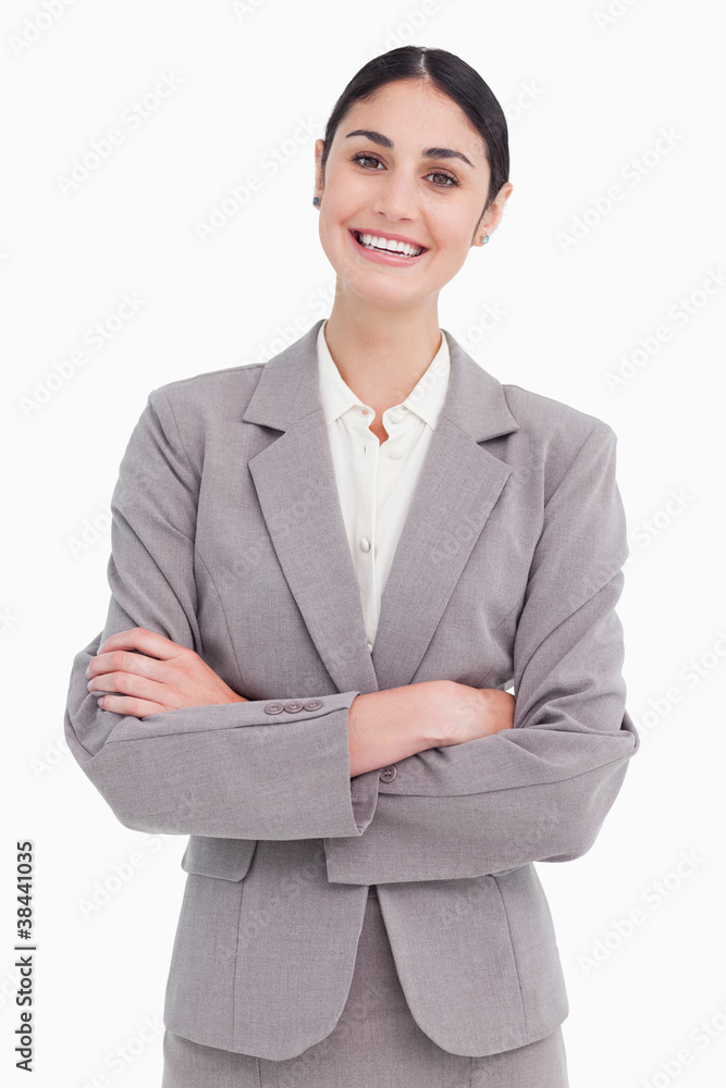Smiling young saleswoman with arms crossed Smiling young saleswoman with arms crossed