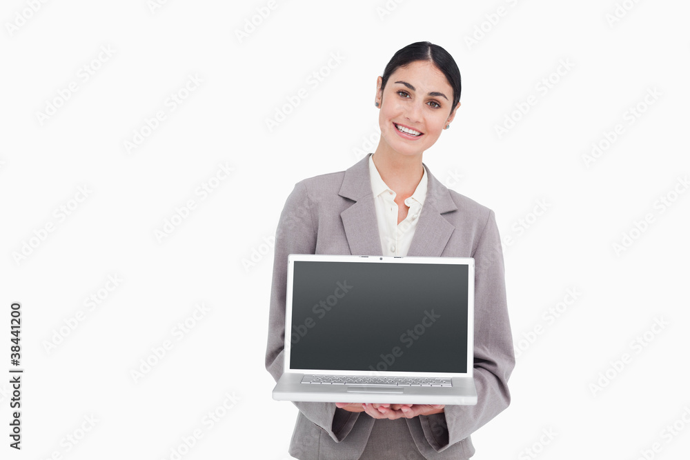 Smiling businesswoman showing screen of her notebook Smiling businesswoman showing screen of her notebook