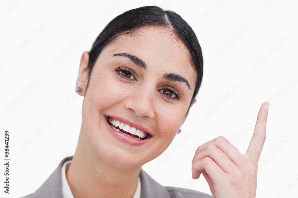 Close up of smiling businesswoman pointing up Close up of smiling businesswoman pointing up
