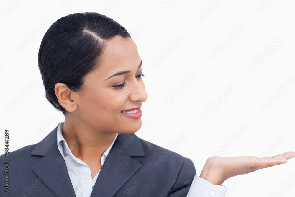 Close up of saleswoman looking at her palm Close up of saleswoman looking at her palm