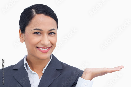 Close up of smiling saleswoman with her palm up