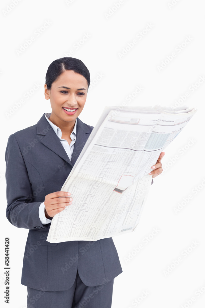 Close up of smiling saleswoman reading the news paper Close up of smiling saleswoman reading the news paper