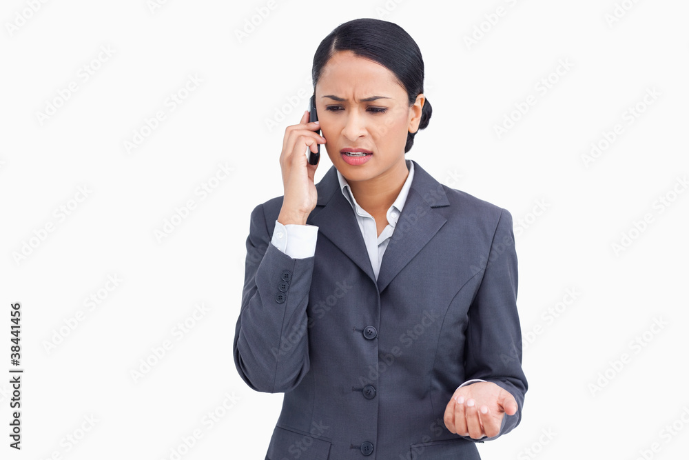 Close up of angry saleswoman in phone conversation Close up of angry saleswoman in phone conversation