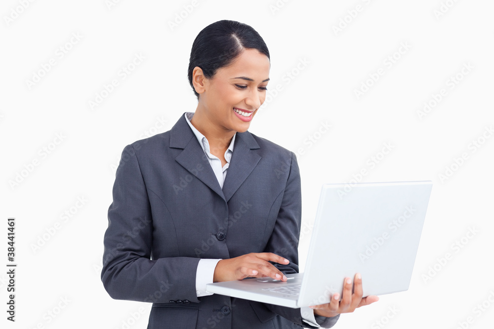 Close up of smiling saleswoman using her laptop Close up of smiling saleswoman using her laptop