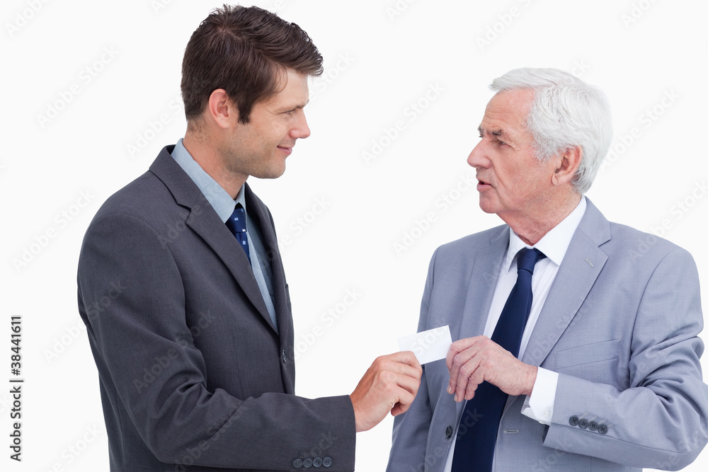 Close up of businessman giving business card to trades partner