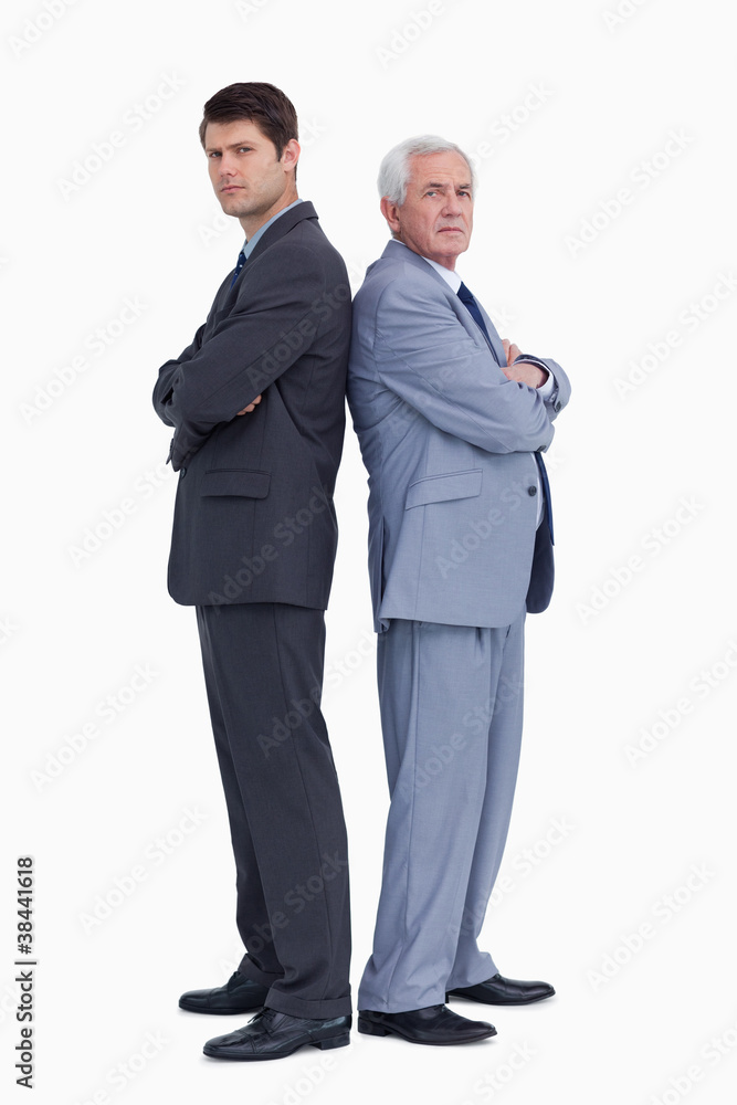 Businessmen standing back to back Businessmen standing back to back