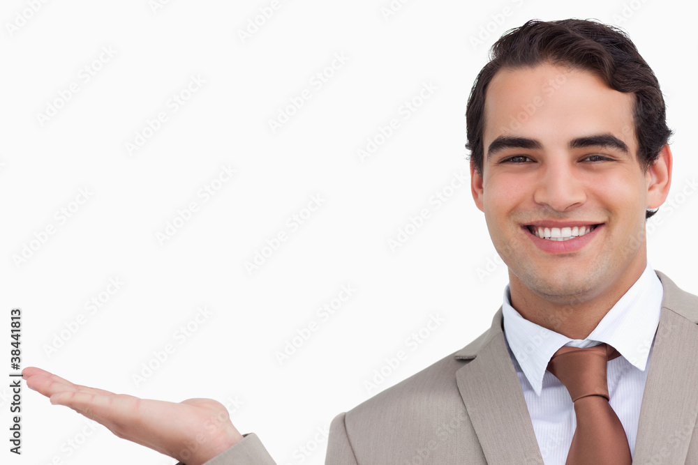 Close up of smiling salesman holding palm up Close up of smiling salesman holding palm up
