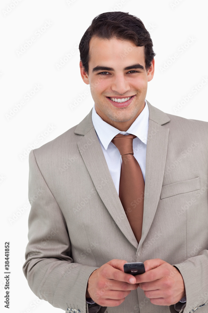 Close up of smiling salesman holding his cellphone Close up of smiling salesman holding his cellphone