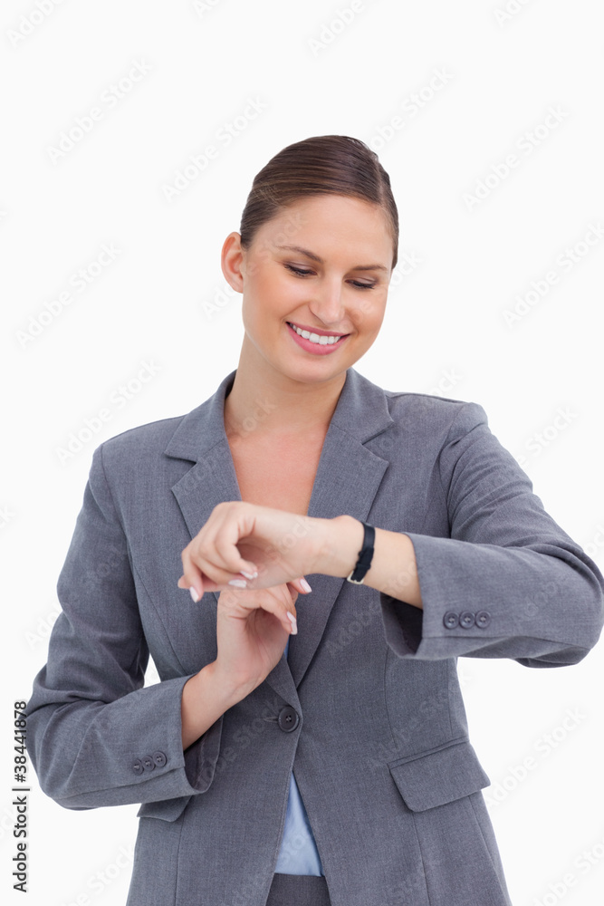Smiling businesswoman looking at her watch Smiling businesswoman looking at her watch