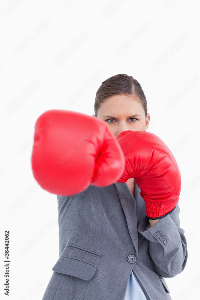 Tradeswoman with boxing gloves attacking with right fist Tradeswoman with boxing gloves attacking with right fist