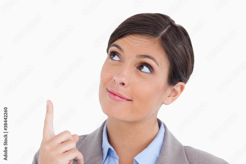 Close up of female entrepreneur pointing and looking up Close up of female entrepreneur pointing and looking up