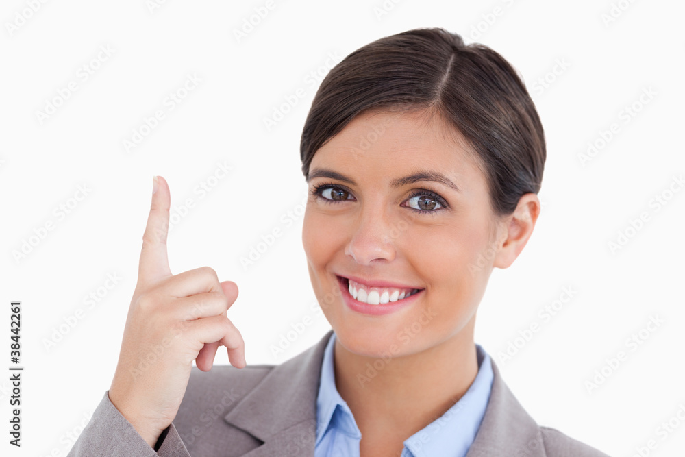 Close up of smiling female entrepreneur pointing up Close up of smiling female entrepreneur pointing up