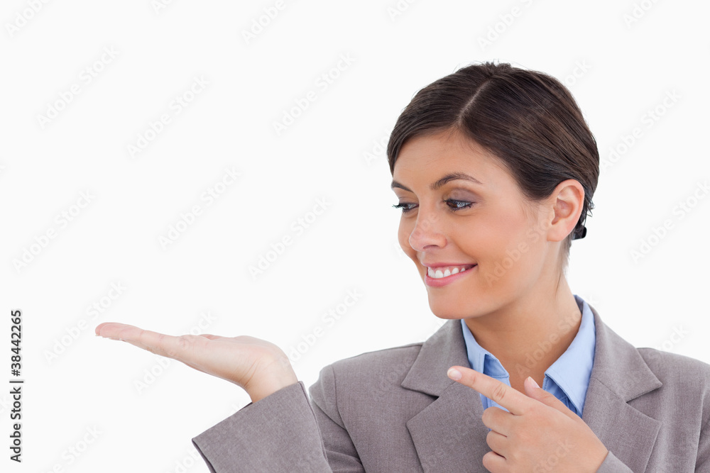 Close up of female entrepreneur looking and pointing at her palm Close up of female entrepreneur looking and pointing at her palm