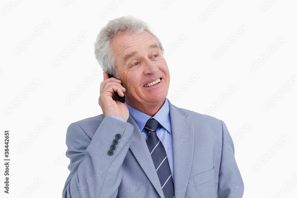 Close up of mature cheerful tradesman on his cellphone Close up of mature cheerful tradesman on his cellphone