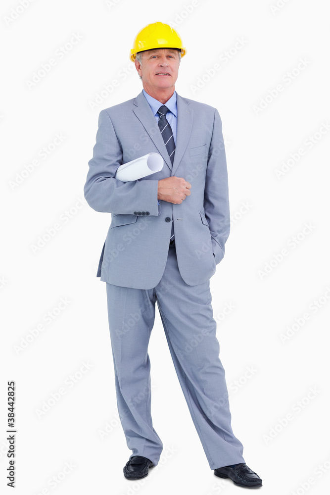 Smiling mature architect with helmet and plans Smiling mature architect with helmet and plans