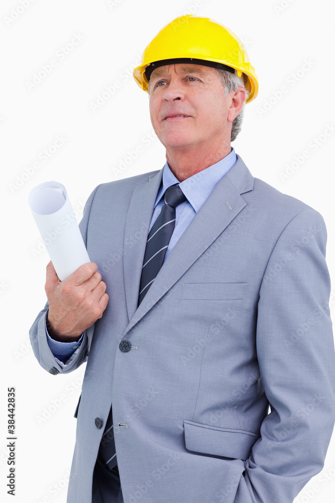 Mature architect wearing helmet and holding plans Mature architect wearing helmet and holding plans