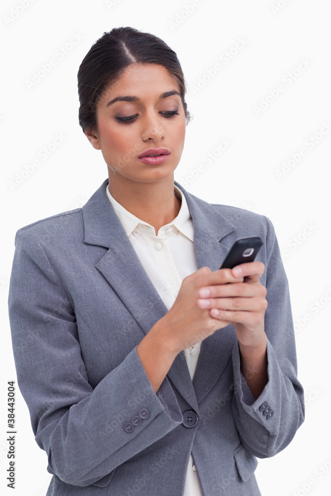 Female entrepreneur writing text message on her cellphone Female entrepreneur writing text message on her cellphone