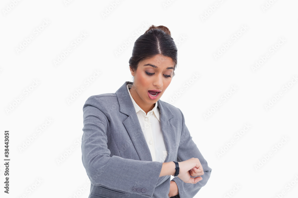 Shocked female entrepreneur looking at her watch Shocked female entrepreneur looking at her watch