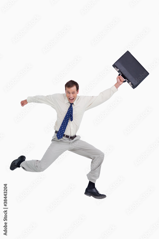 Cheerful jumping businessman with his suitcase Cheerful jumping businessman with his suitcase