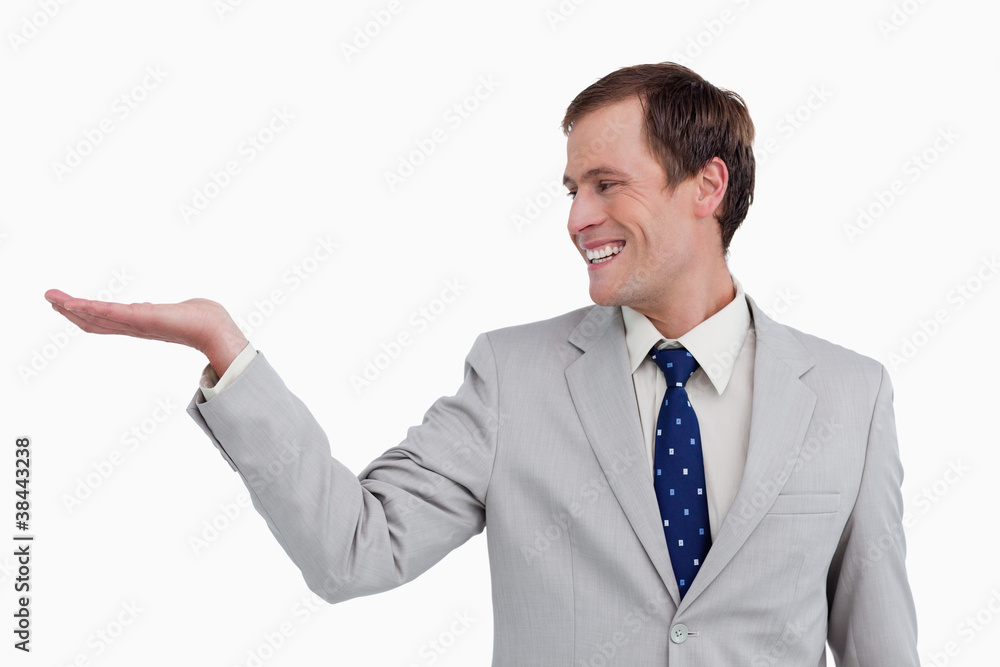 Close up of smiling businessman looking at his palm Close up of smiling businessman looking at his palm