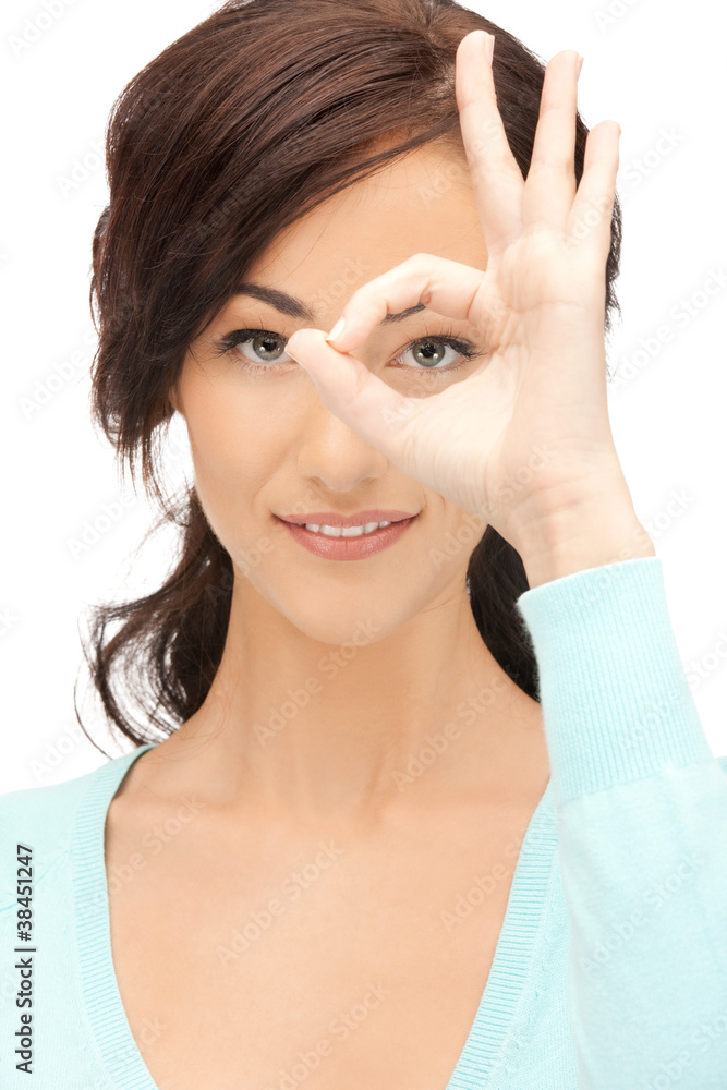 lovely woman looking through hole from fingers lovely woman looking through hole from fingers