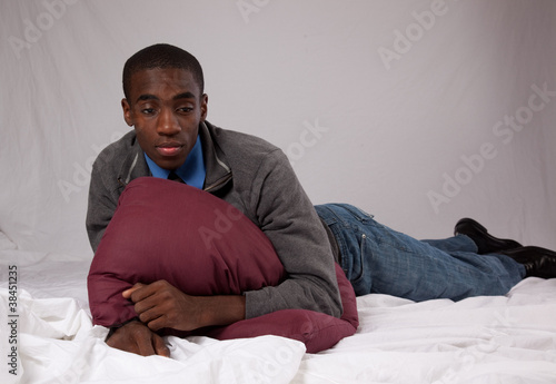 black man in grey sweater, reclining