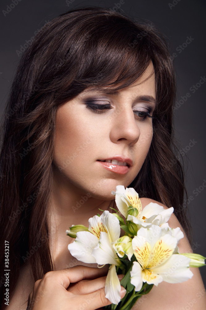 Beautiful woman holding a flower Beautiful woman holding a flower