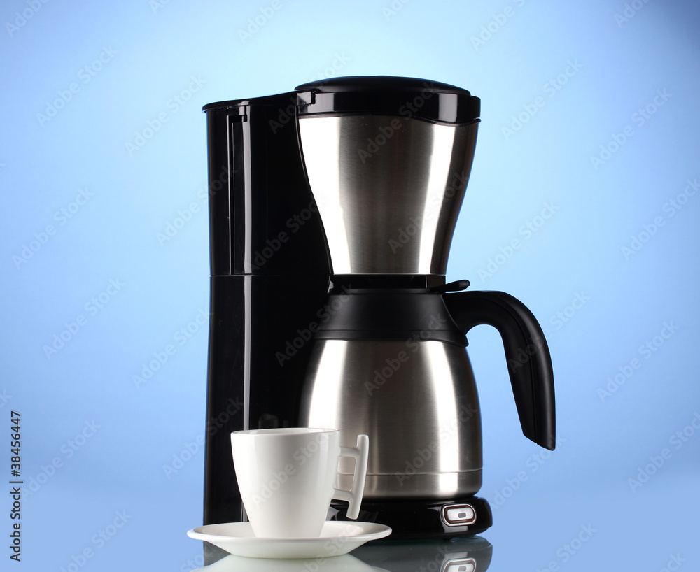 Coffee maker with white cup on blue background Coffee maker with white cup on blue background