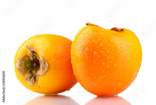 Two appetizing persimmons with droplets isolated on white
