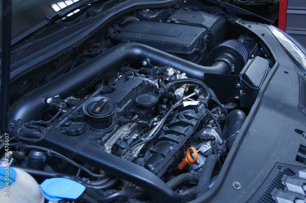 mechanic repairs a car in a garage