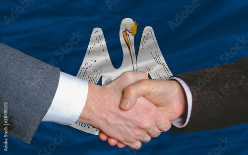 in front of american state flag of louisiana two businessmen han photo