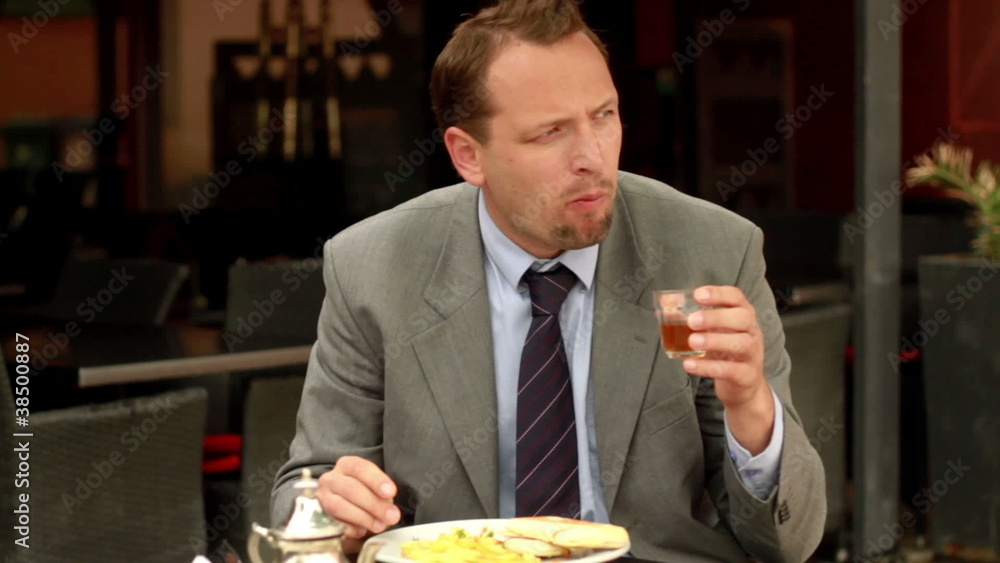Businessman eating lunch in cafe, steadicam shot Businessman eating lunch in cafe, steadicam shot