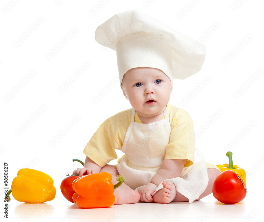Portrait of a baby wearing a chef hat with healthy  food vegetab