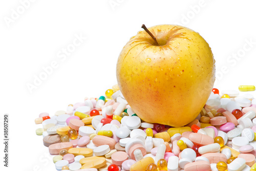 Apple and pills on white background
