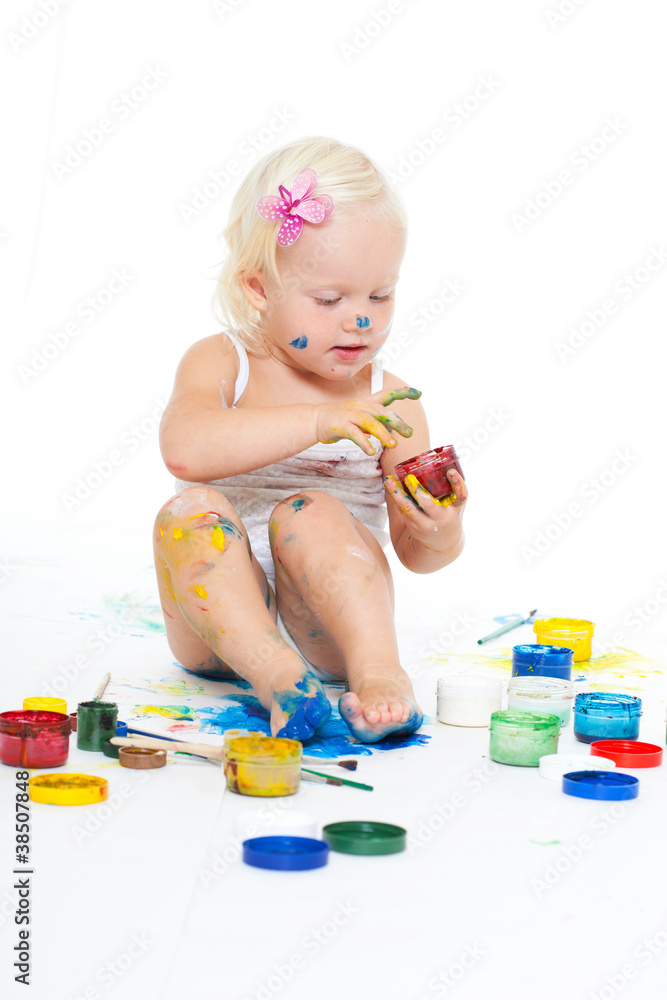 little girl bedaubed with bright colors little girl bedaubed with bright colors