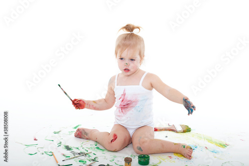 little girl bedaubed with bright colors