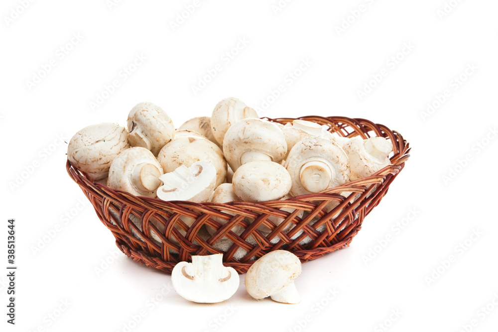 champignones in wooden basket isolated on white champignones in wooden basket isolated on white