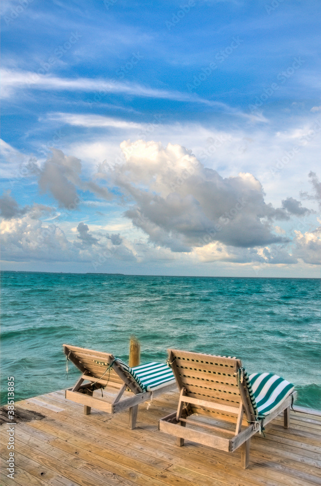 Beach Chairs on a Dock Overlooking the Ocean