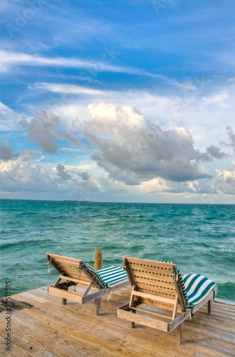 Beach Chairs on a Dock Overlooking the Ocean © ClimberJAK