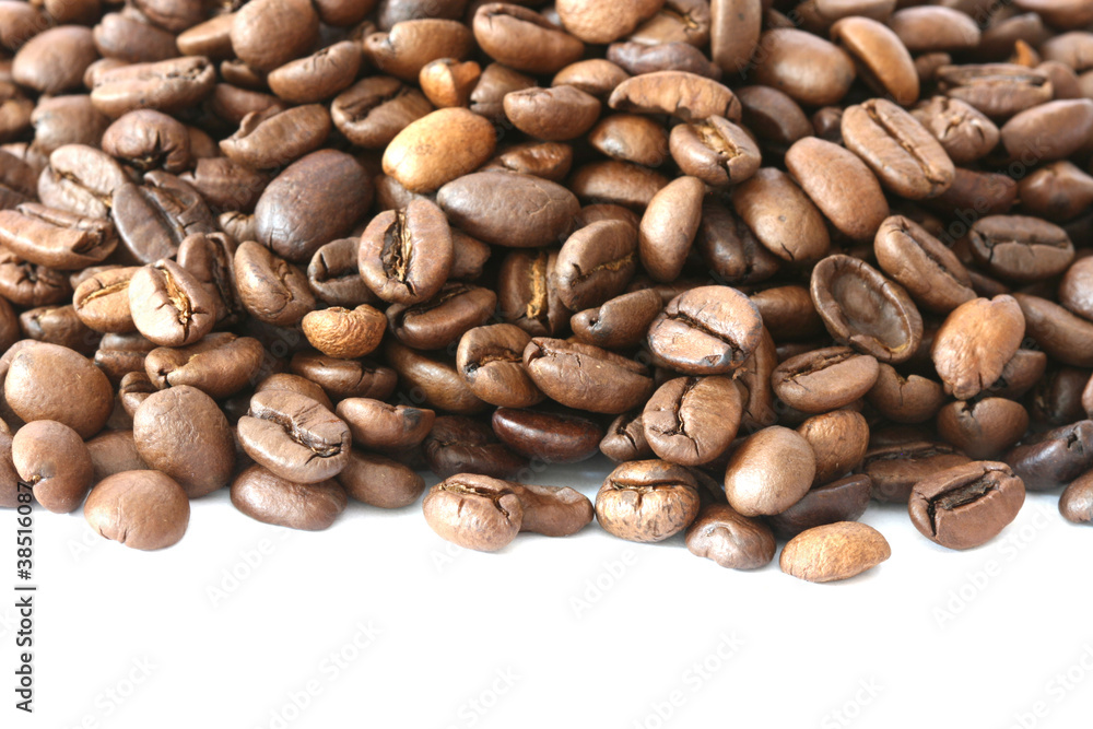Whole coffee beans scattered on white background Whole coffee beans scattered on white background