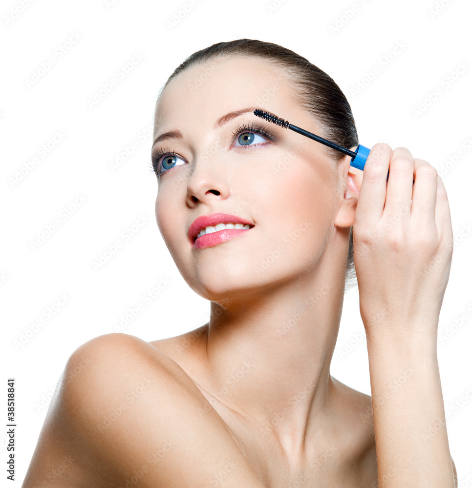 Beautiful woman applying mascara on eyelashes Beautiful woman applying mascara on eyelashes