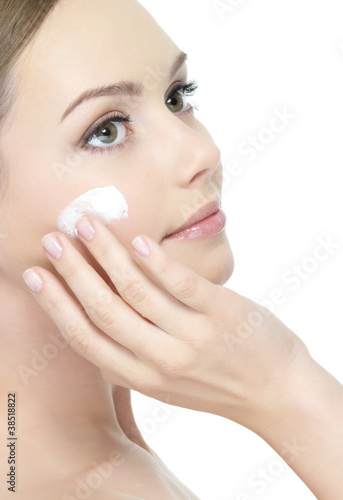 Beautiful woman with cream on face