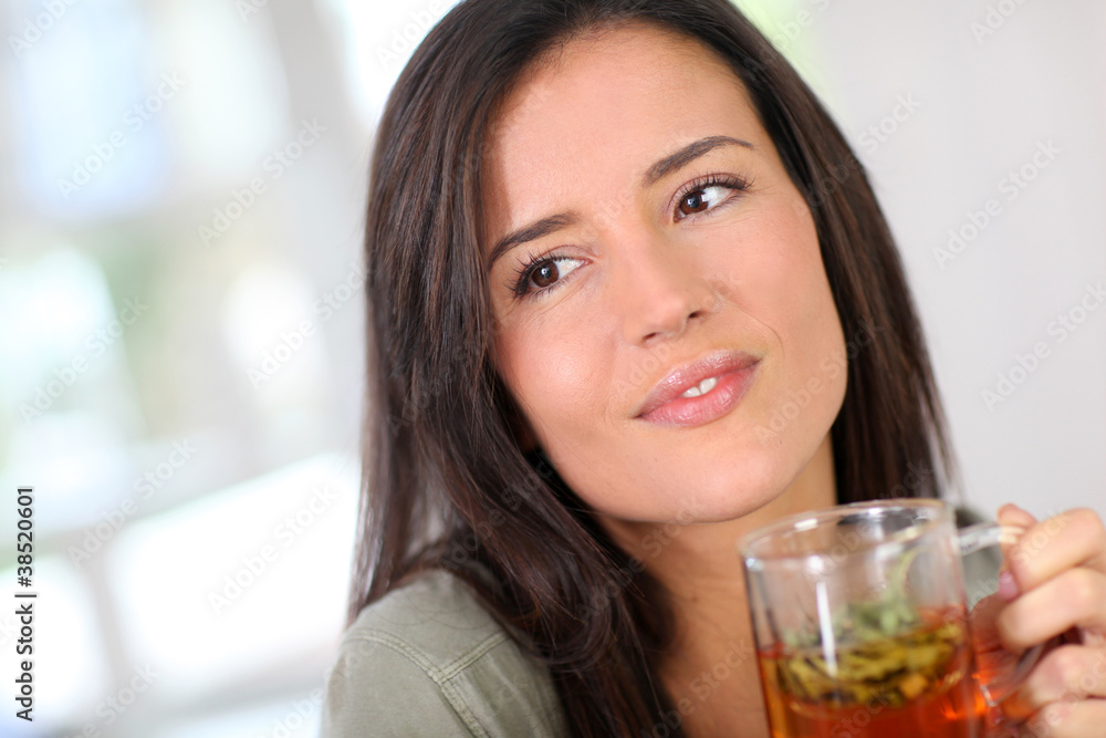 Portrait of young woman drinking herbal infusion Portrait of young woman drinking herbal infusion