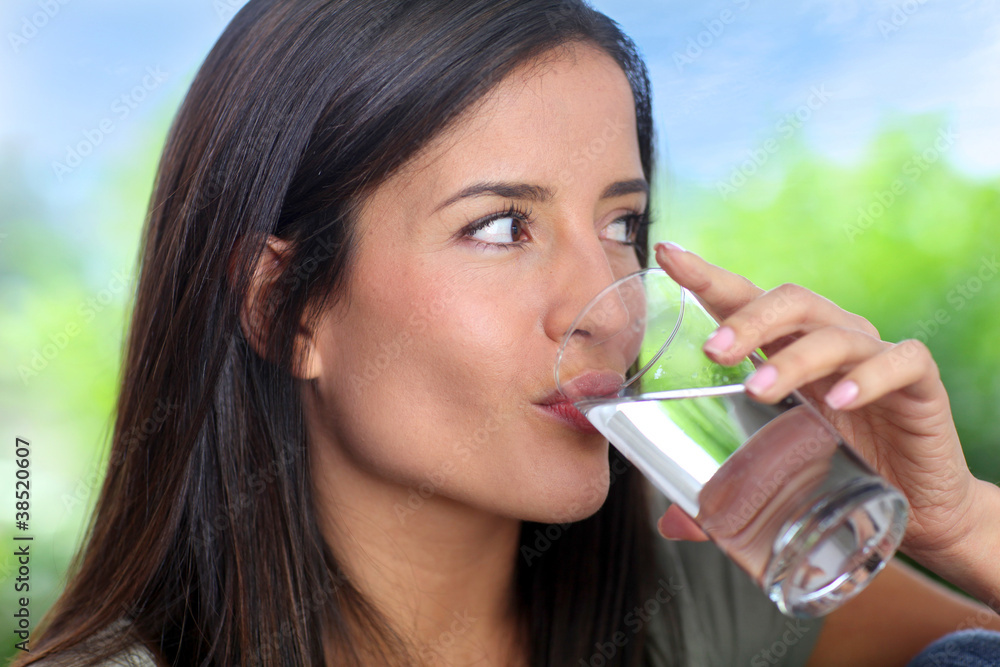 Portrait of smiling woman holding glass of water Portrait of smiling woman holding glass of water
