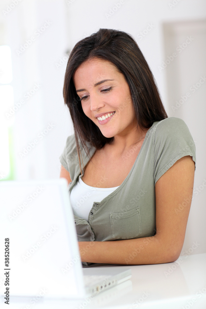 Beautiful young woman working at home on laptop computer Beautiful young woman working at home on laptop computer