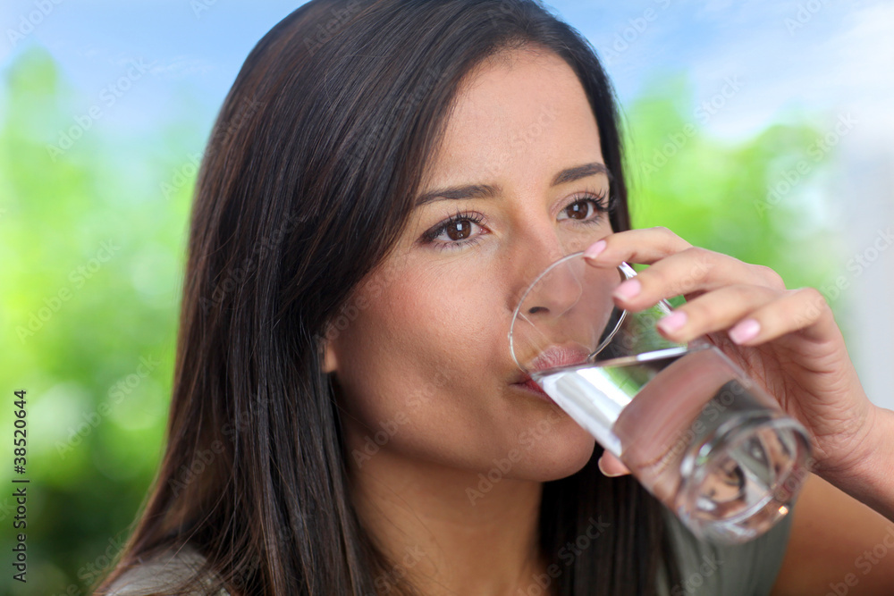 Portrait of smiling woman holding glass of water Portrait of smiling woman holding glass of water