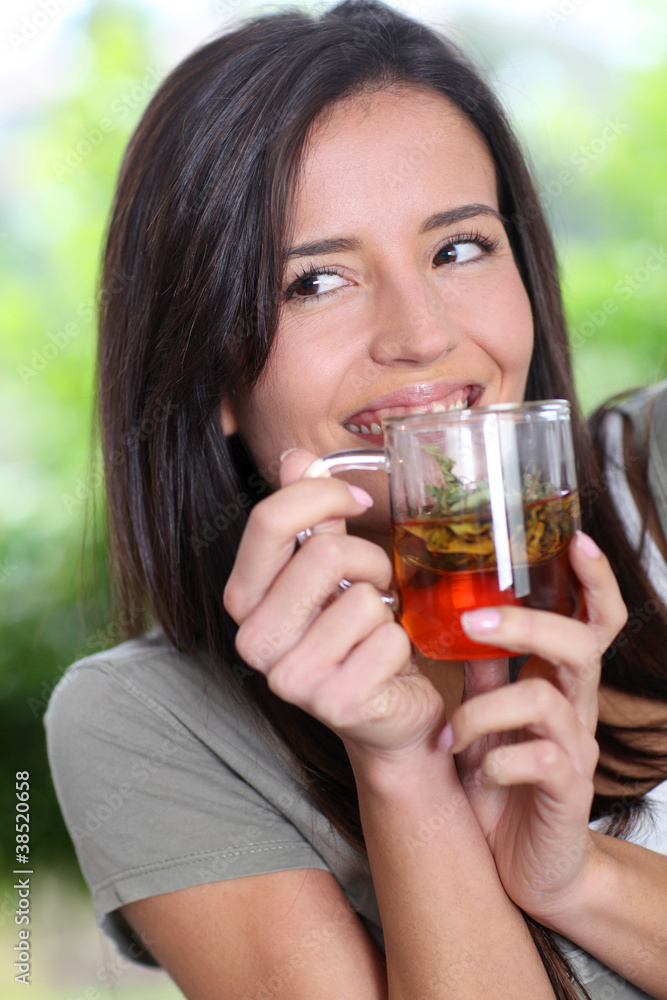Portrait of young woman drinking herbal infusion Portrait of young woman drinking herbal infusion
