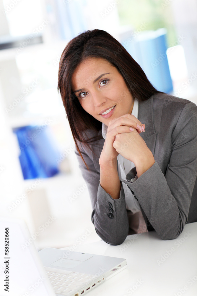 Businesswoman sitting in front of laptop computer Businesswoman sitting in front of laptop computer