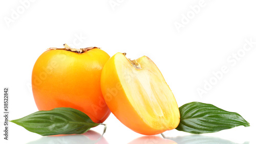 One and half appetizing persimmon with green leaves isolated