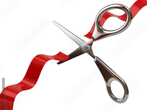 Silver scissors cutting red ribbon